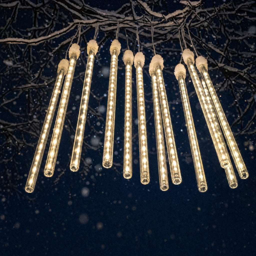 A set of ten warm white meteor light tubes hanging from a snowy branch
